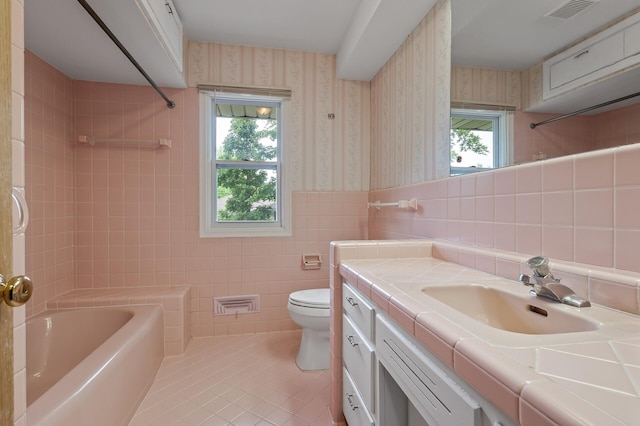 4700 Glenwood Ave, Golden Valley, MN 55422 - bathroom featuring wallpapered walls, tile walls, tile patterned floors, vanity, and  shower combination