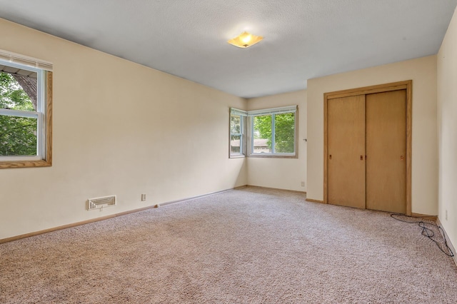 4700 Glenwood Ave, Golden Valley, MN 55422 - unfurnished bedroom featuring light colored carpet and a closet