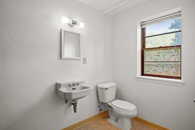 bathroom featuring tile patterned flooring, toilet, and sink