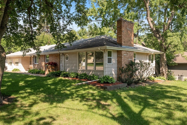 4700 Glenwood Ave, Golden Valley, MN 55422 - view of front facade featuring a chimney, a front yard, and brick siding