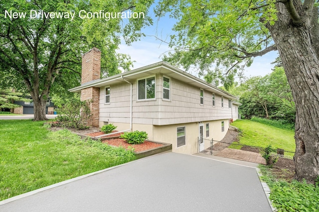 view of side of property with a yard