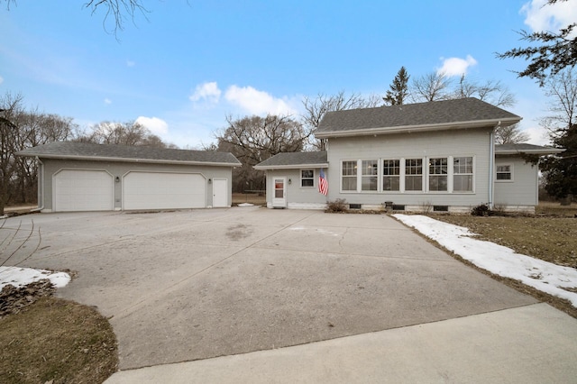 view of front of house featuring a garage and an outdoor structure