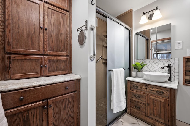 bathroom featuring tile patterned floors, decorative backsplash, vanity, and an enclosed shower