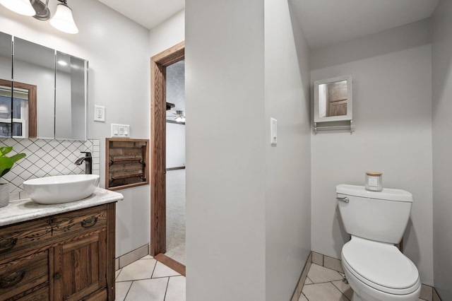 bathroom with decorative backsplash, tile patterned flooring, vanity, and toilet