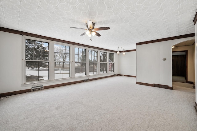 spare room with ceiling fan, carpet floors, and ornamental molding