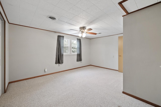 carpeted spare room with ceiling fan