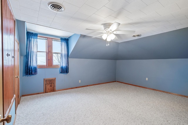 additional living space featuring carpet, ceiling fan, and vaulted ceiling