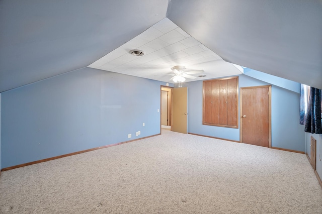 additional living space featuring carpet, vaulted ceiling, and ceiling fan