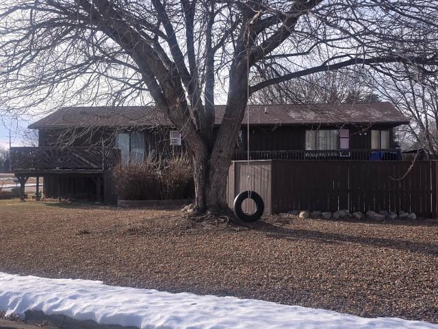 view of snow covered rear of property