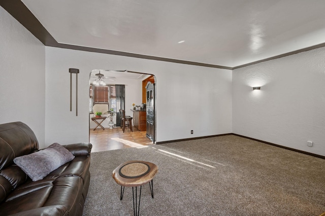 unfurnished living room featuring ornamental molding and light carpet