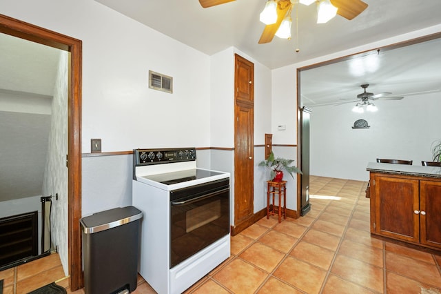 kitchen featuring white electric range, ceiling fan, and light tile patterned flooring