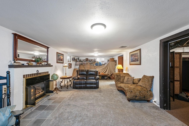 living room featuring carpet, a textured ceiling, and a brick fireplace