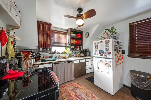 kitchen with stove, dishwashing machine, ceiling fan, sink, and white fridge