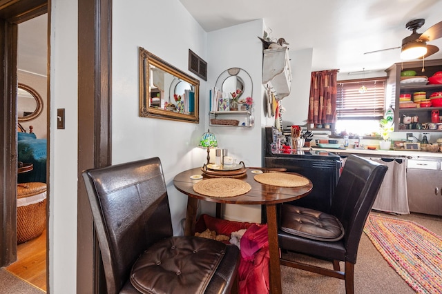 dining space featuring ceiling fan and carpet floors