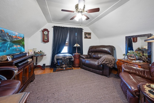 living room featuring carpet flooring, ceiling fan, and vaulted ceiling