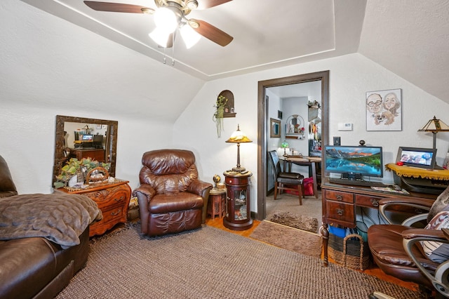 living room with ceiling fan and vaulted ceiling