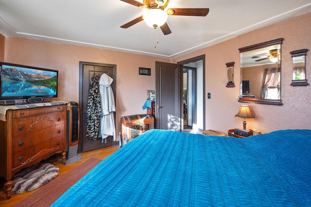 bedroom with ceiling fan and light hardwood / wood-style floors