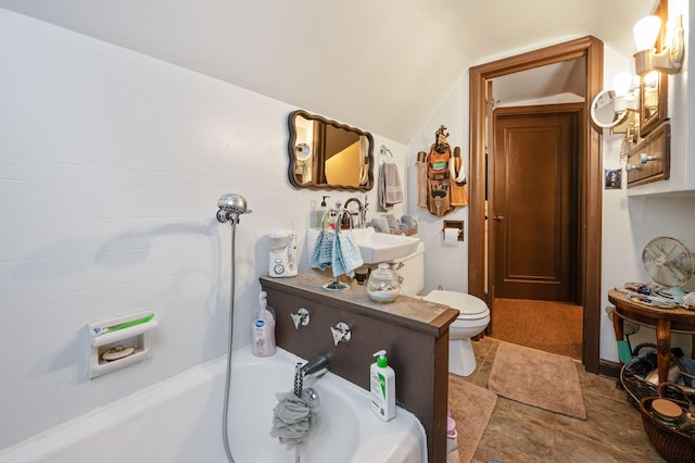 bathroom featuring sink, a washtub, lofted ceiling, and toilet