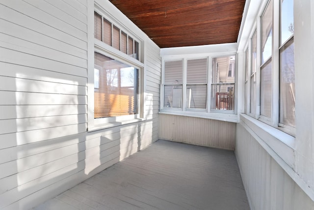 unfurnished sunroom with wooden ceiling