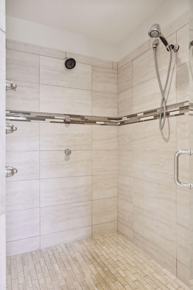 bathroom with tiled shower