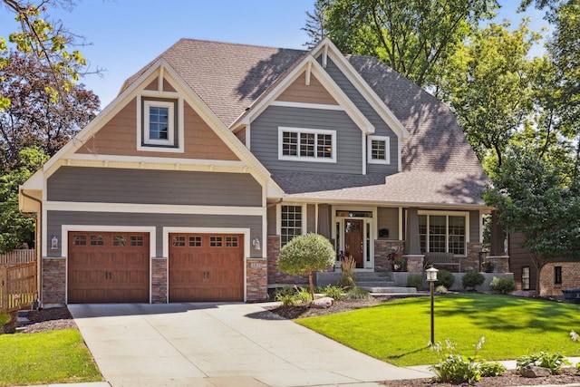 craftsman inspired home featuring a garage and a front yard