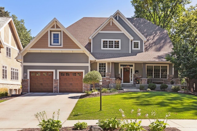 craftsman-style house featuring a garage, a porch, and a front lawn