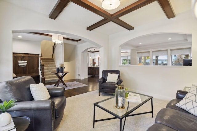 living room featuring beamed ceiling and hardwood / wood-style floors