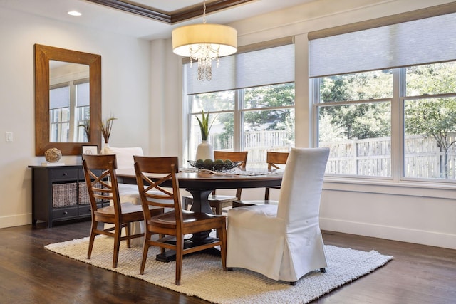 dining space featuring dark wood-type flooring, plenty of natural light, and a chandelier