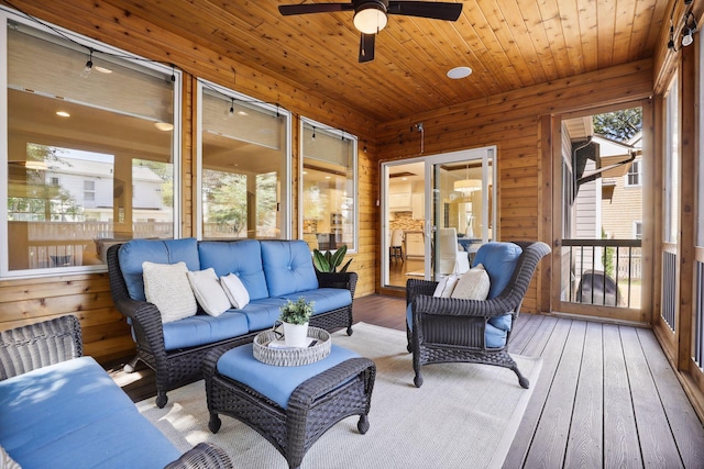 sunroom featuring wood ceiling and ceiling fan