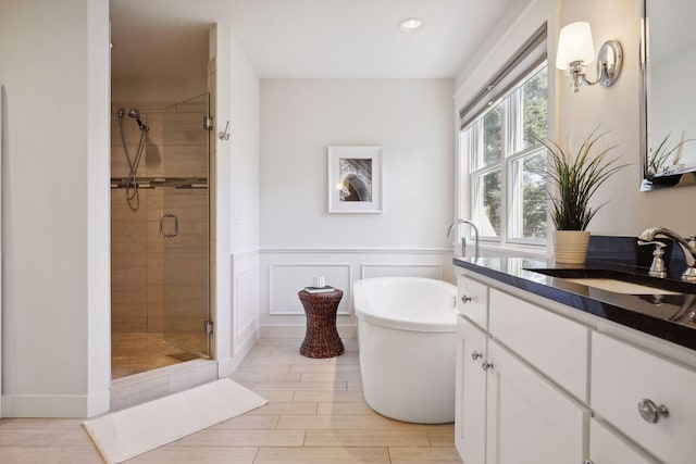 bathroom with vanity and separate shower and tub