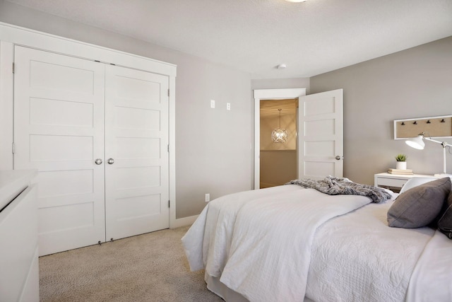 bedroom with light colored carpet and a closet