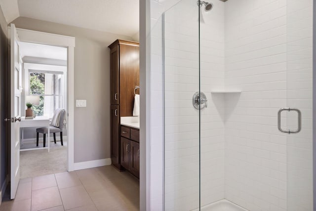 bathroom with vanity, an enclosed shower, tile patterned flooring, and a textured ceiling