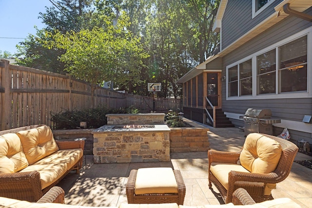 view of patio / terrace featuring area for grilling, an outdoor living space, and a sunroom