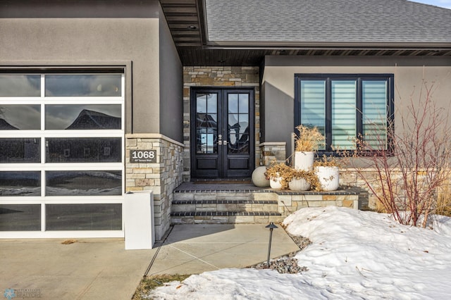 snow covered property entrance with french doors