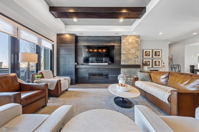 living room featuring beamed ceiling and a fireplace