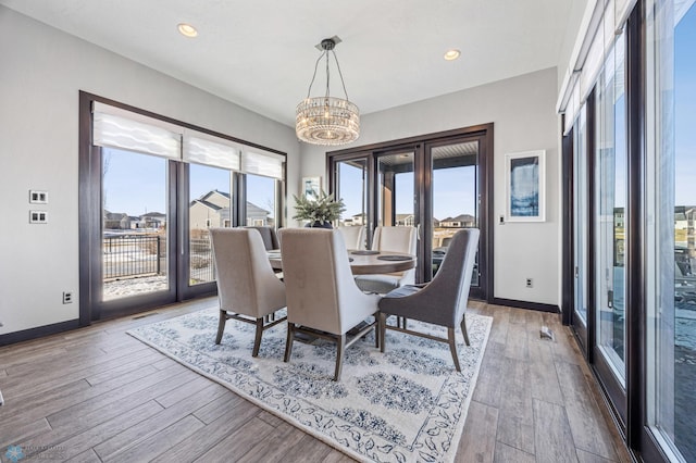 dining room featuring hardwood / wood-style flooring and a chandelier