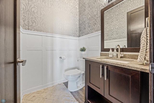 bathroom featuring vanity and toilet