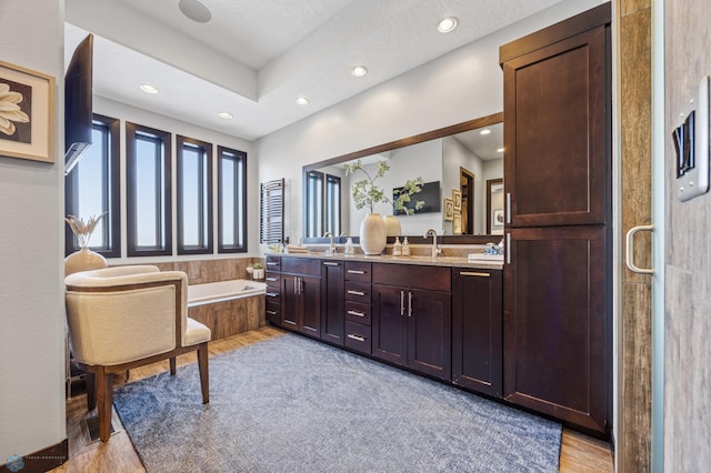 bathroom with hardwood / wood-style flooring, vanity, and independent shower and bath