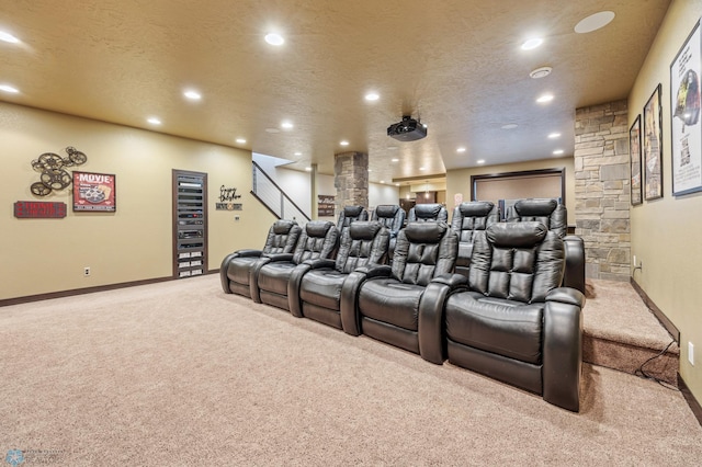 carpeted home theater room featuring a textured ceiling