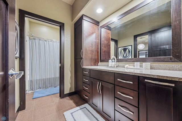 bathroom featuring a shower with curtain, tile patterned flooring, and vanity