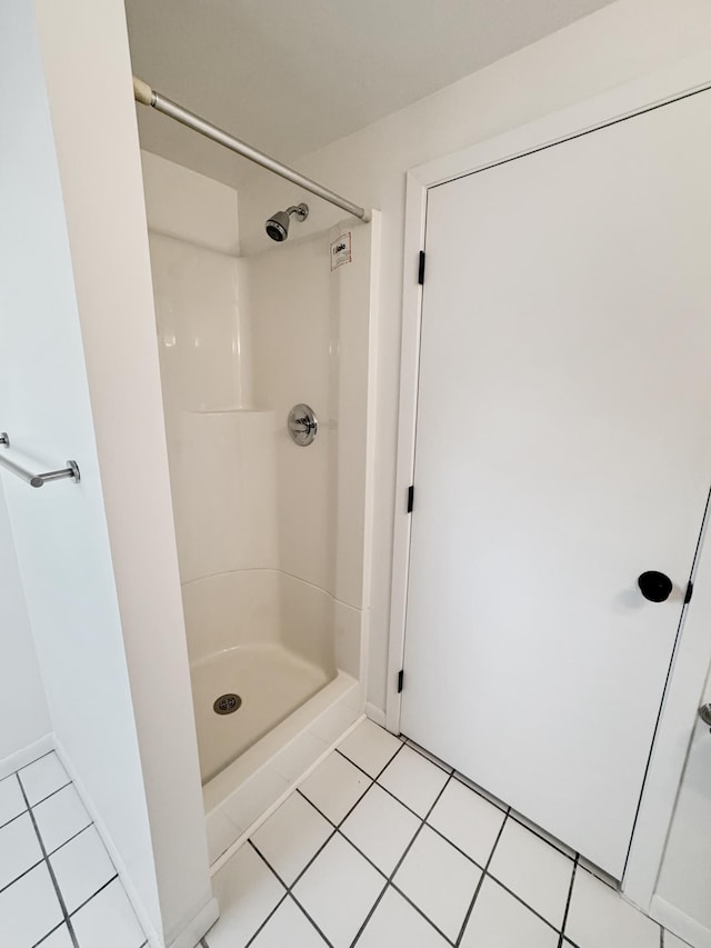 bathroom featuring tile patterned flooring and a shower