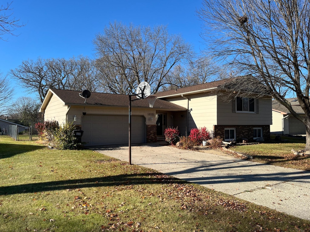 view of front of home with a garage and a front lawn