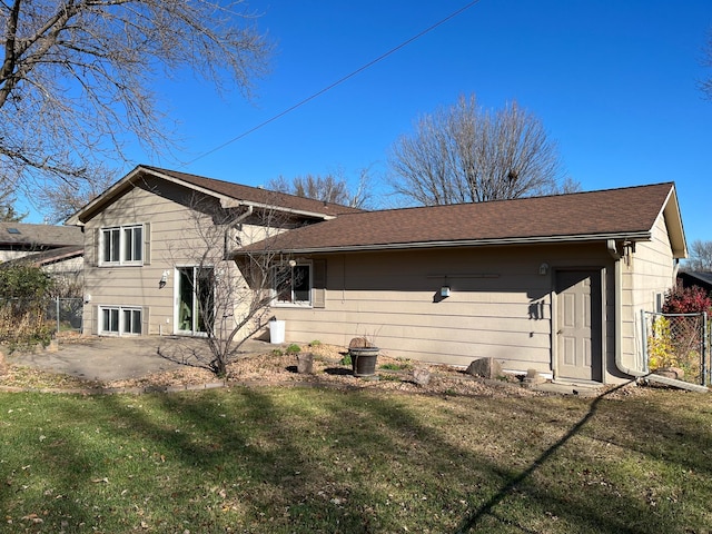 rear view of house featuring a yard