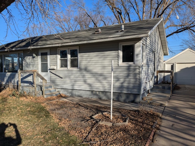 view of front facade with an outbuilding and a garage