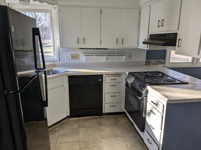 kitchen with black appliances, light tile patterned flooring, and white cabinetry