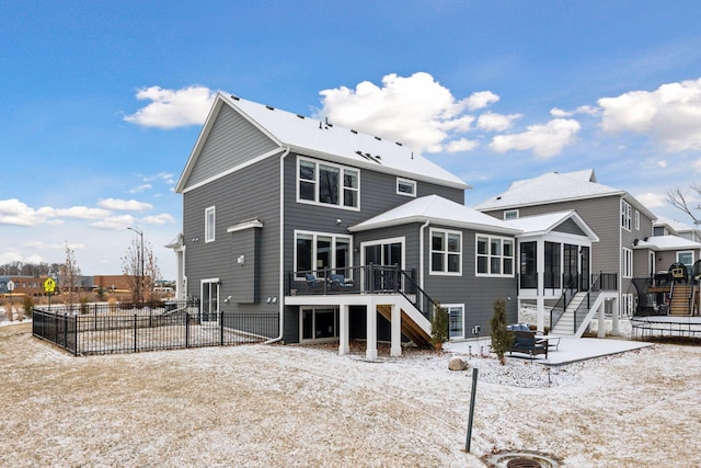 rear view of house featuring a deck and a sunroom