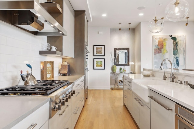 kitchen featuring pendant lighting, extractor fan, and white cabinets