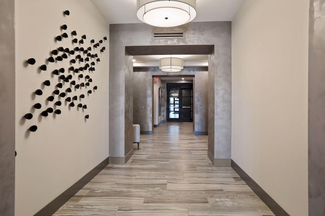 corridor with light hardwood / wood-style floors