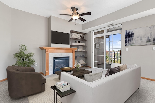 living room with light carpet, a fireplace, and ceiling fan