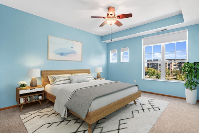 carpeted bedroom with multiple windows and ceiling fan